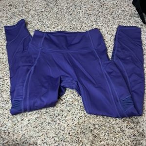 Purple leggings that have a slight stain but are in great condition otherwise.